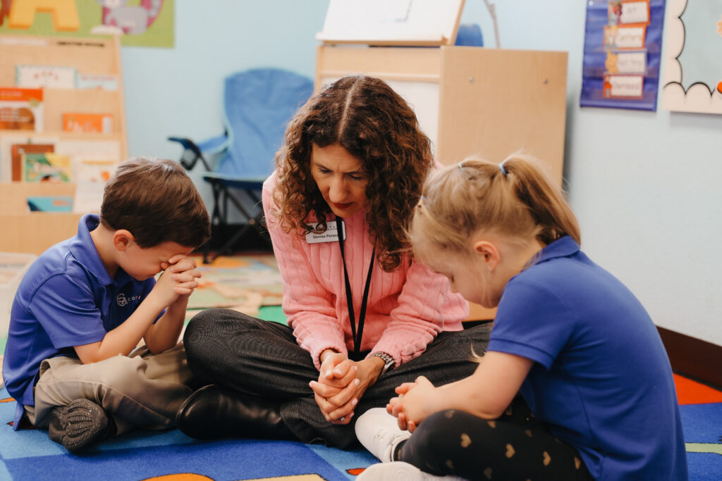 Teacher sitting with students