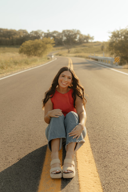 high school senior picture of girl sitting in the road